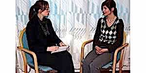 therapist taking notes seated next to lady client