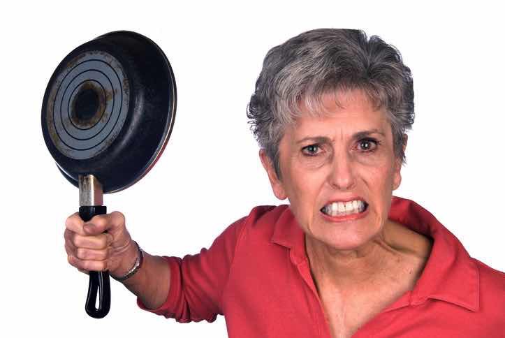 angry grandmother about to hit with frying pan