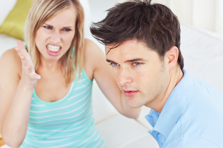 Woman screaming at puzzled man