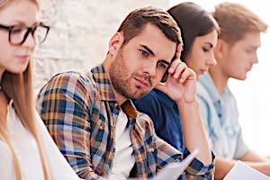 man trying hard to think of answer to test