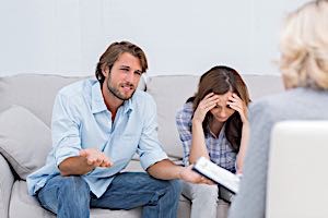 man and woman having therapy with therapist