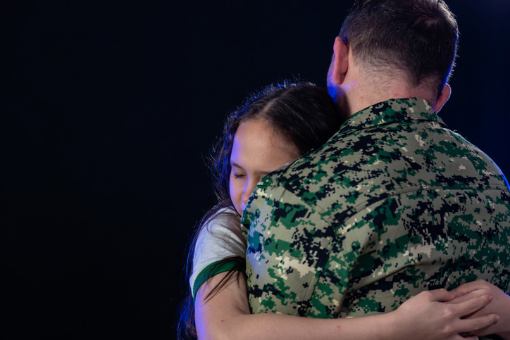 wife hugging soldier who is just returning from war