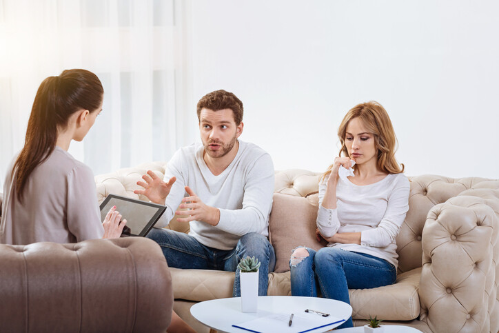 married couple discussing their problems with a therapist.