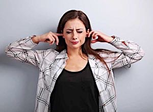 woman with fingers in her ears