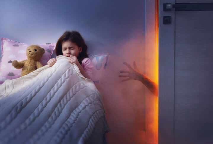 child girl in bed having nightmare scared