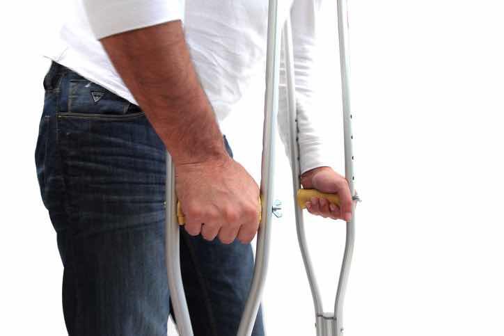 depressed man on crutches