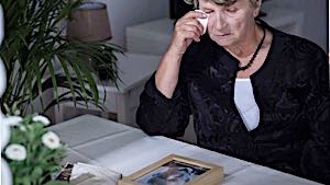 sad woman looking at photo of deceased husband