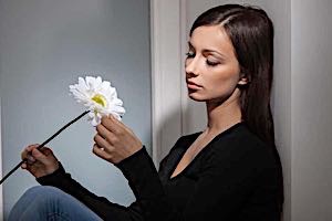 depressed woman with flower