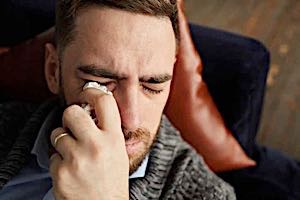 man crying sad tears with handkerchief after arguing romance