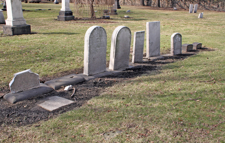 Lonely gravestones in field
