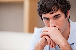 young adult man deep in disturbing thoughts