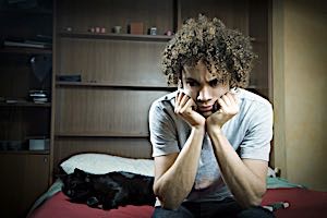 Depressed and unmotivated teenager with head in hands