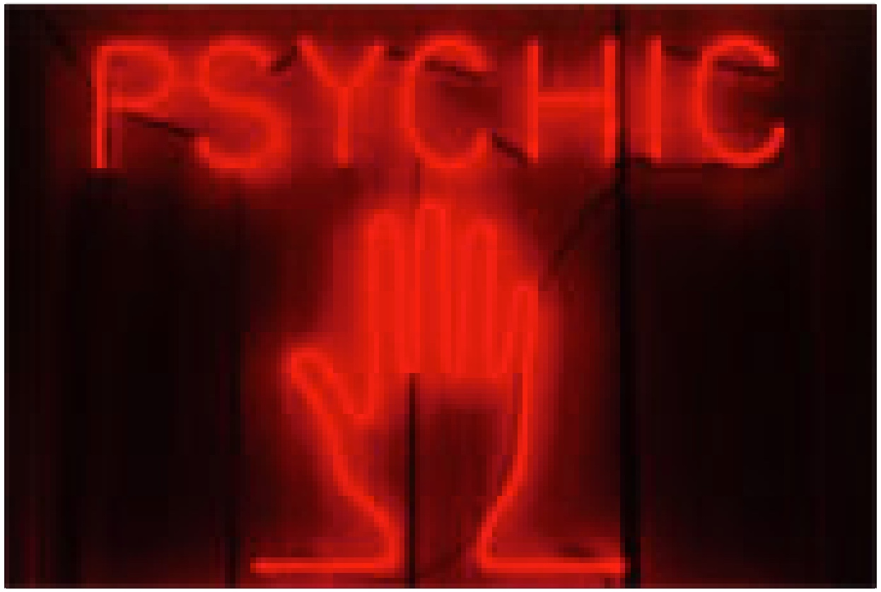 neon sign of hand and word 'psychic'