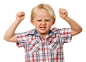 angry look on child clenching fists and 