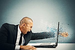 stressed  angry man punches at computer screen