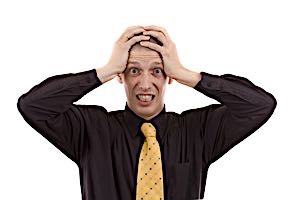 forgetful man clasps his head