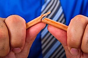 stressed man breaks pencil