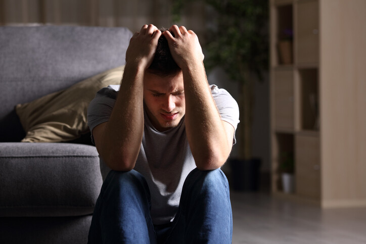 anxious man with head in arms