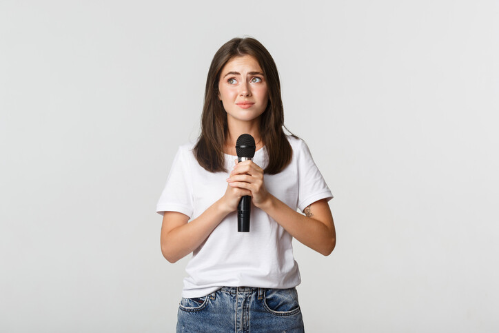 shy woman holding microphone