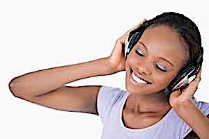 smiling happy dreamy girl listing on headphones