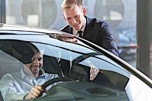 guilty looking man buying expensive car spending money