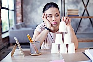 bored lazy woman fiddling at desk