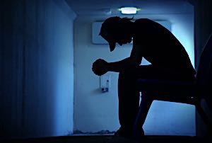 boy sitting looking hopeless