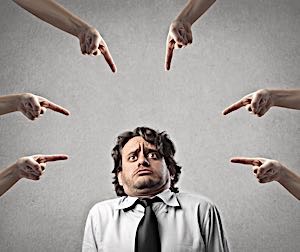 puzzled man with many fingers pointing at him