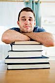 man with stack of unopened books