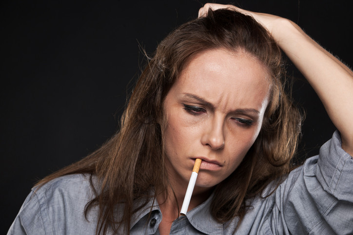 unhappy woman smoking