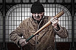 mean looking thug holding baseball bat threatiningly 