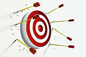 archery target surrounded by arrows that all missed target