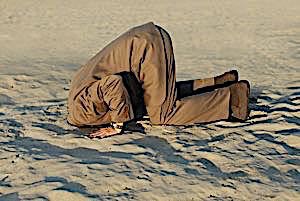 man with his head in the sand evading the issue