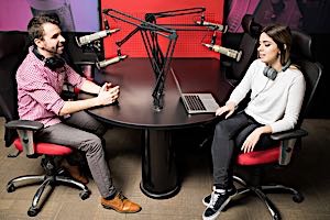 man and woman at broadcasting studio