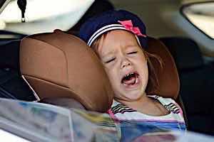 unhappy toddler in car seat screaming