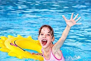 girl in pool inflatable float happy waving