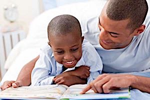 Father reading with his young son