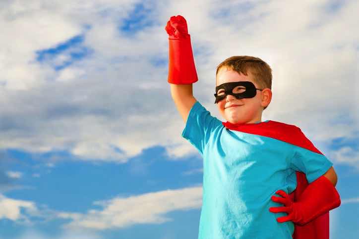 proud independent boy in superhero costume