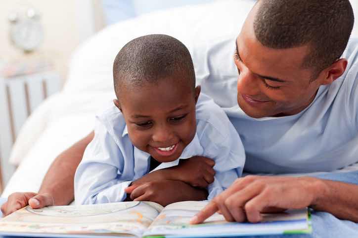 Happy father reading to happy son