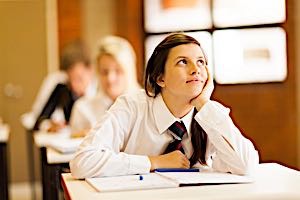 Teenage girl daydreaming in classroom