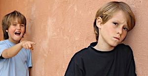 older brother torments and teases younger handicapped brother