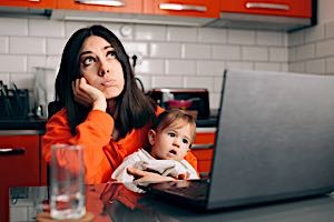 Bored mother holding infant