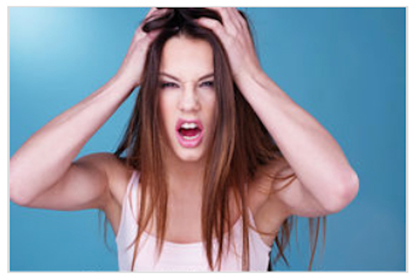Mother of violent young daughter pulling out her own hair in frustration