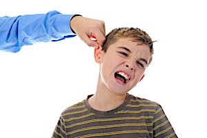 boy has painful look as man pinches his ear