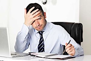 Businessman at desk working hard and alone