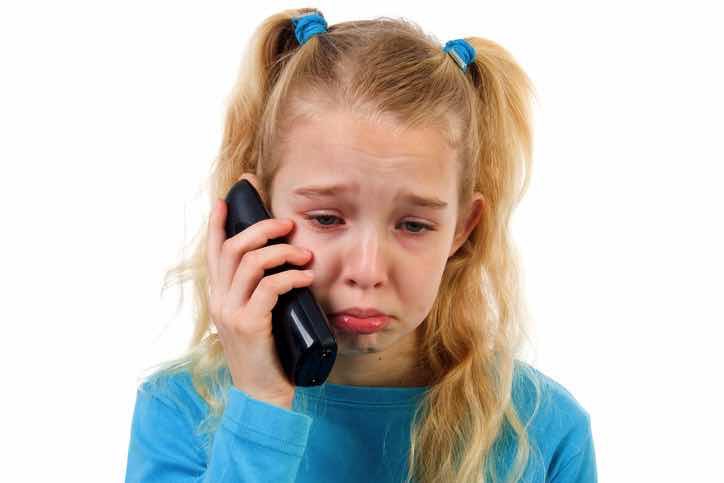 sad child girl on phone