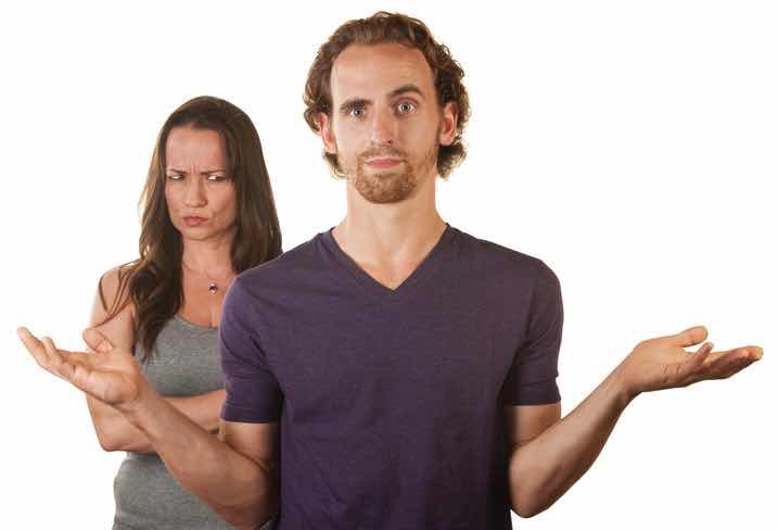 a woman with scrunched up face and a puzzled man