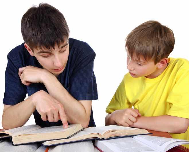 Older Brother helps Little Brother with homework