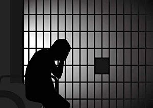 man sitting in jail silhouette