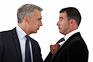 angry businessman  threatens scared businessman